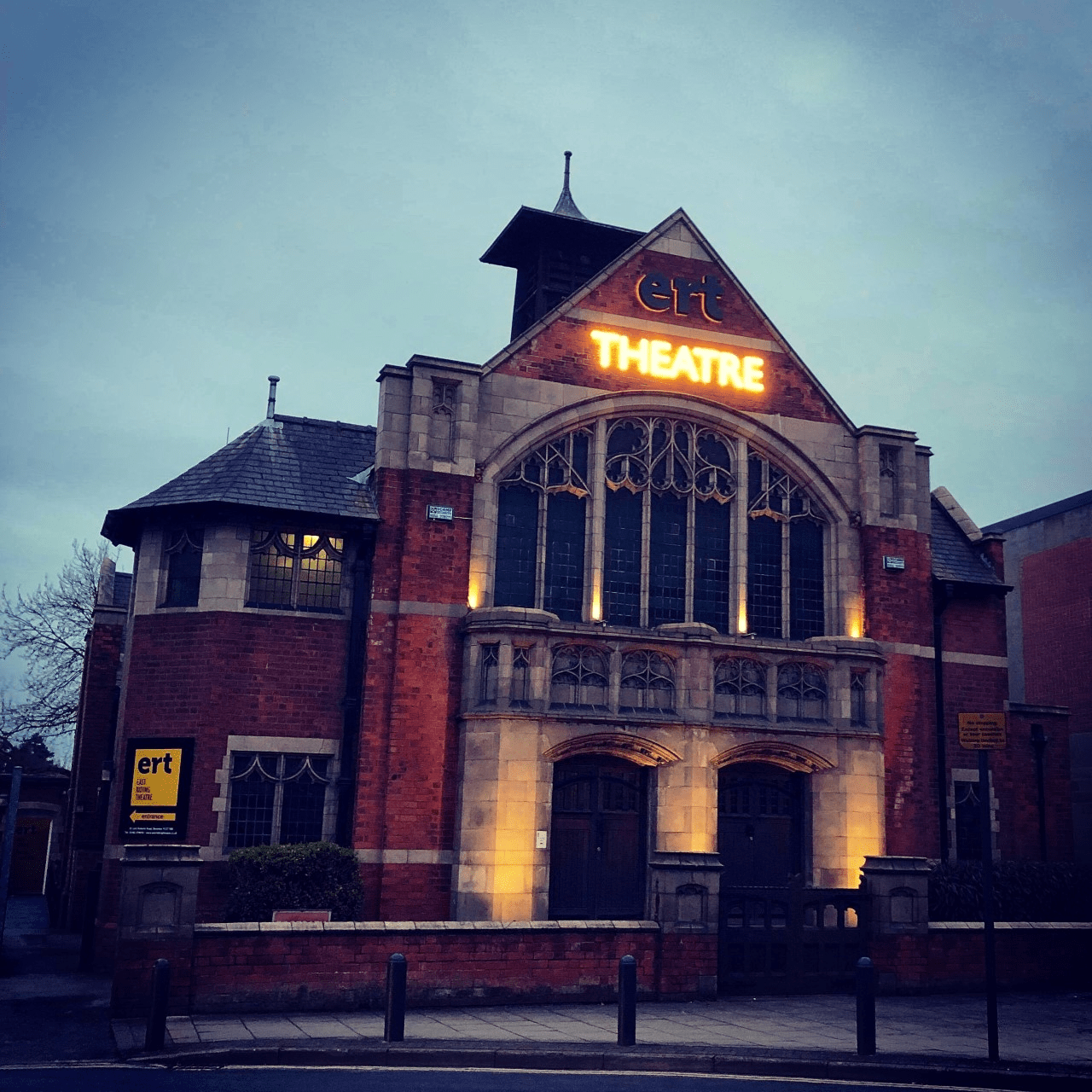 Image of the East Riding theatre building at night, illuminated by lights.